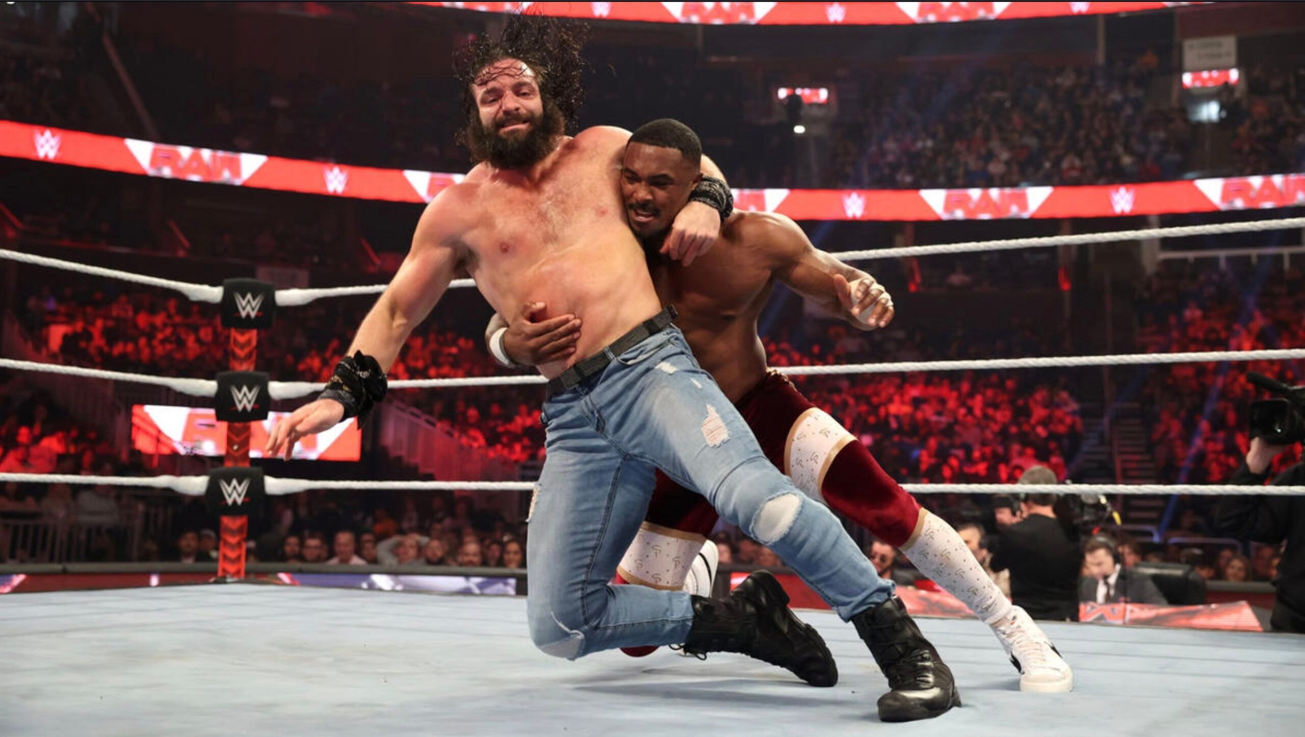 Elias Behind Seth Rollins
