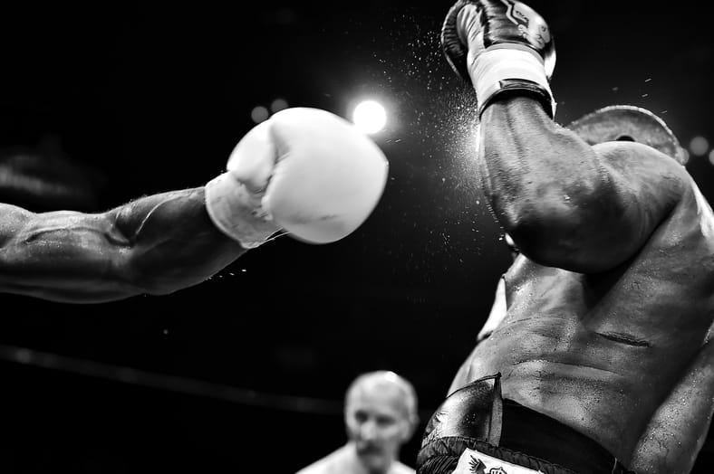 two people fighting black and white