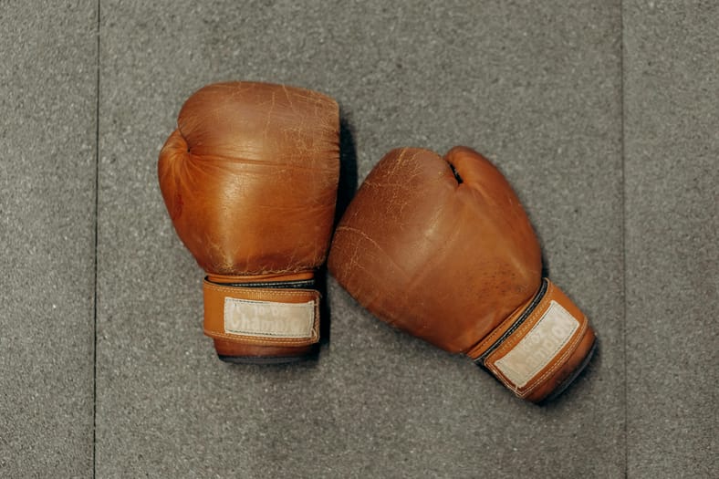 brown-boxing-gloves-on-gray-floor