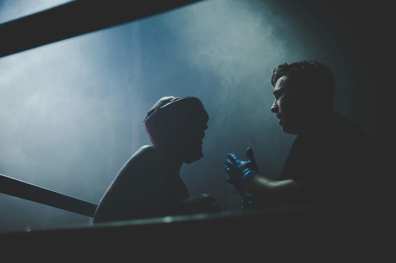 coach talking to boxer