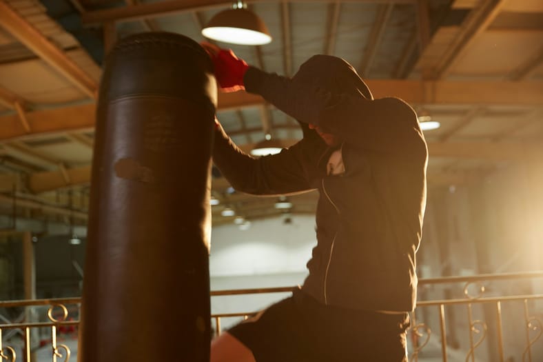 man hitting punching bag