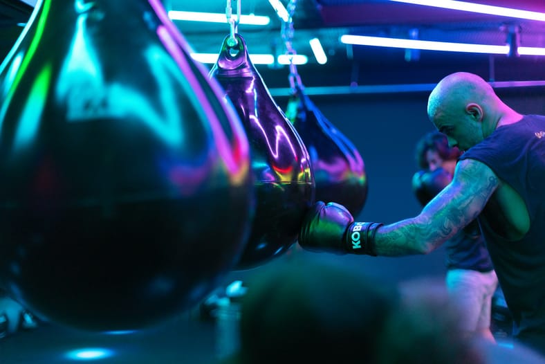 man hitting punching bags